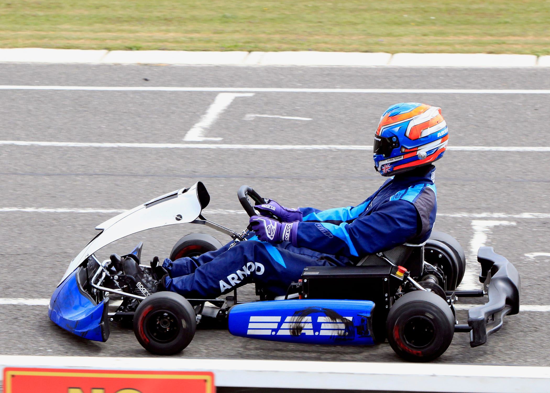 Side profile of Keelan at speed in his blue FAT kart